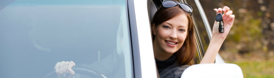 successful happy woman with car key holding